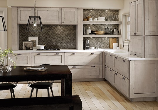 Transitional kitchen in Aged Concrete finish with herringbone tile backsplash