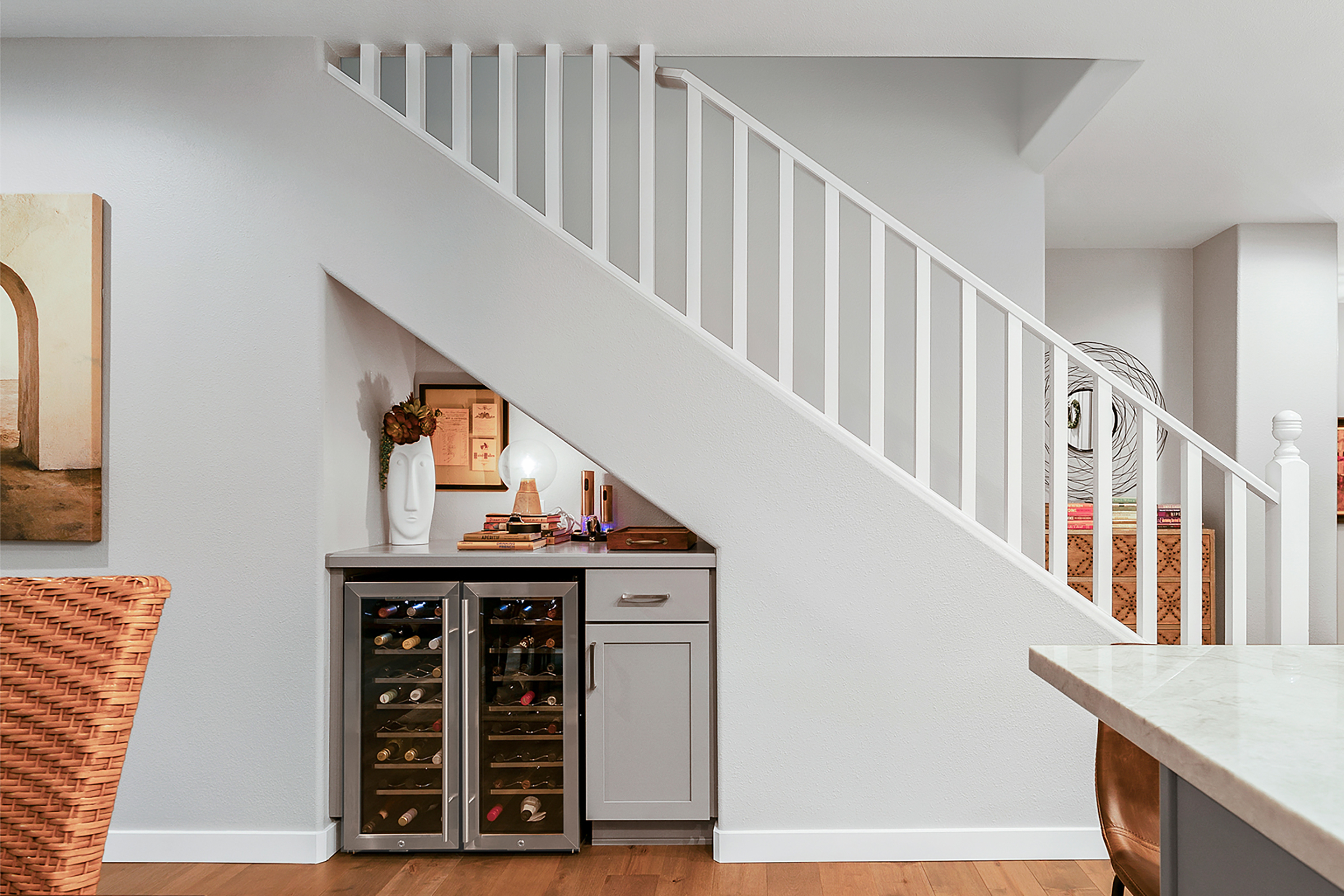 KraftMaid Shaker-style cabinet door and wine cooler tucked into under-stair alcove