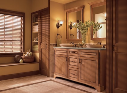 Transitional bathroom with two vessel sinks on top of a KraftMaid vanity in Ginger with Sable Glaze